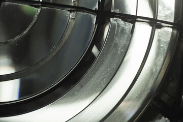 Bright illuminated Fresnel lens with glowing reflections in a dark background