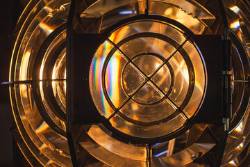 Lighthouse lamp is glowing behind a Fresnel lens, showcasing its prismatic design