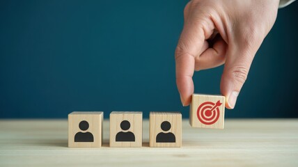 A hand places a wooden block with a target icon in front of person icons