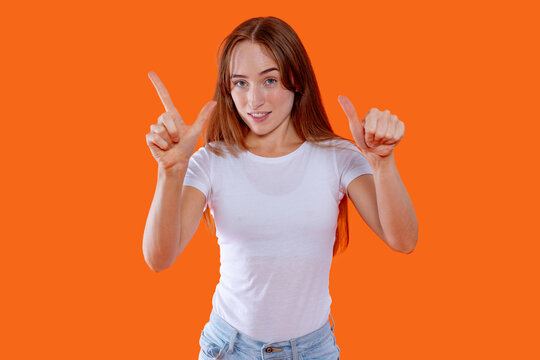 Smiling woman showing three fingers with both hands against a bright orange background in a cheerful indoor setting