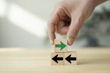 Navigating the Right Path: A hand carefully places a green arrow block atop a stack of blocks with opposing black arrows, symbolizing choices and decisions. The action is set against a natural.