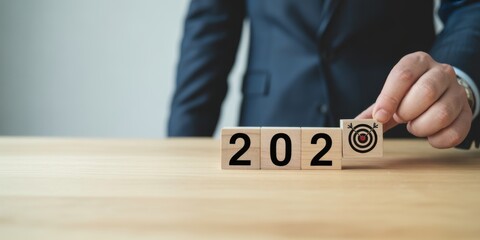 Focus on 2024: A focused individual in business attire strategically positions a block with the number 2024 and a target icon, symbolizing goal-setting, planning, and vision for the future.