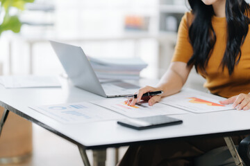 Focused Designer's Workspace: A person's hands diligently sketch designs at a modern desk, surrounded by technology, and inspiration.