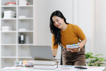 Office Productivity: A focused office worker, surrounded by stationary, diligently works, showing a commitment to her tasks, a modern workspace for maximum productivity.