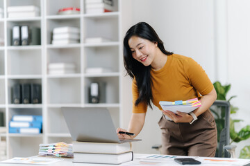 Focused Professional: A poised professional woman, engrossed in her work, meticulously examines documents, reflecting an atmosphere of dedication and efficiency.