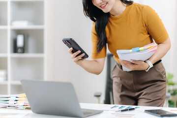 Digitizing Efficiency: A professional woman streamlines her workflow, capturing essential information with her smart phone, while the innovative use of technology enhance productivity.