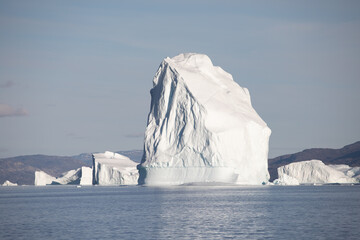 A huge floating iceberg off the coast of Greenland that threatens maritime transport. Ecology, melting ice, climate change, global warming background