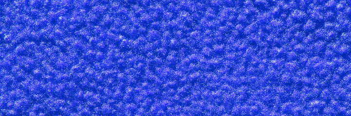 Close-up of vibrant blue textured surface with soft fibrous patterns for abstract background.