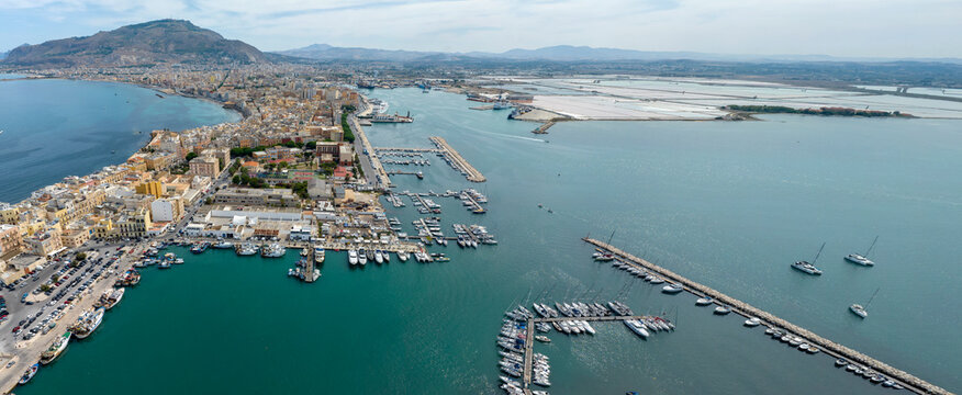 Panoramic aerial view of Trapani, Sicily, Italy. It is a Sicilian city with a port overlooking the Mediterranean Sea. Mount Erice dominates the town in the background.