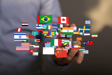 A hand holding flags from various countries represents global connection, community, and...