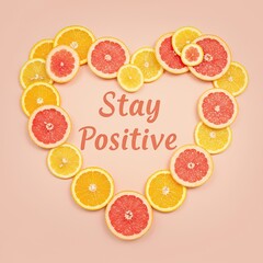 Heart shape citrus fruit arrangement with positive message on pink background