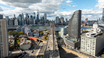 New York City, New York USA - 10-24-2025: Suspended over the Brooklyn Bridge, this symmetrical photo captures Lower Manhattan’s skyline rising majestically above the East River.