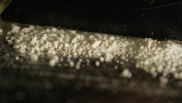 Drugs cocaine or oxy substances abuse and addiction. Hard illegal drugs. Preparing strips of white powder to blow. Drugs trafficking. Opioid crisis and opiates epidemic. Painkillers medications abuse.