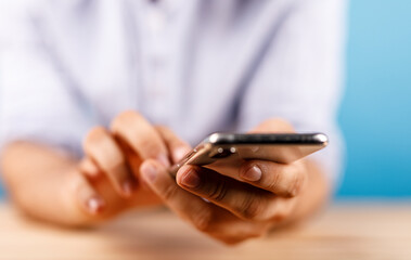 Close up shot of a person hands interacting with smartphone device, browsing mobile phone, using social media