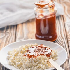 Savory couscous dish with spicy sauce and jar