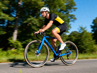 competitive cyclist speeding on road, dressed in racing gear and helmet