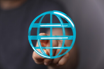 Hand pointing at a digital globe icon, symbolizing connection, internet, worldwide network, and global communication.