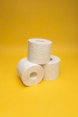 Blooming rapeseed field and wind power turbines during sunny day