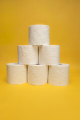 Blooming rapeseed field and wind power turbines during sunny day