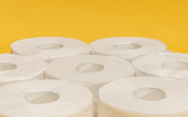 Blooming rapeseed field and wind power turbines during sunny day