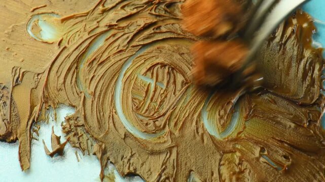 spreading chocolate with a fork, chocolate-covered marshmallow pieces, close-up, cocoa cream.