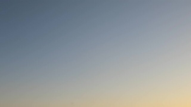 Soft dawn sky with blue and beige gradient tones before sunrise for peaceful background