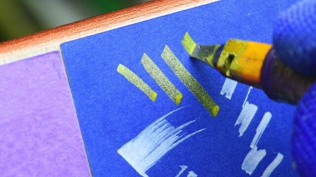writing with gold ink, flat nib pen, close-up.