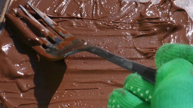spread chocolate with a fork, close-up, chocolate cream.