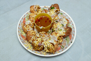 Fuchka Indian street food with this delightful plate of golgappa chaat, a perfect blend of crispy textures and tangy spices that will tantalize your taste buds.