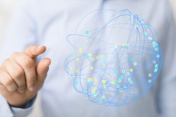 A person's hand touching a digital globe illustrating a network of interconnected points and lines symbolizing global communication and data sha