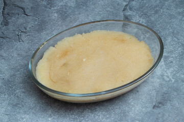 Shujir Halwa or sooji sweet semolina pudding, perfectly prepared in a clear glass dish. A delightful, wholesome dessert ready to be shared and savored.