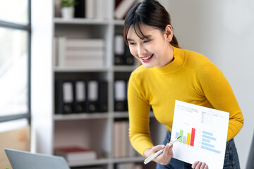 Asian Young Woman Presenting Business Data Analysis on Charts and Graphs During Online Meeting Explaining Financial Strategy and Marketing Plan