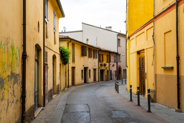 Yellow old narrow empty Italian street. Colorful houses in Rimini city Italy travel architecture