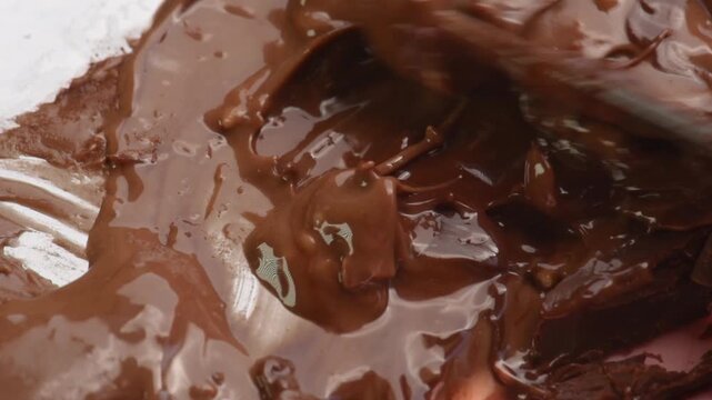 Mix chocolate pieces with chocolate cream, spread close-up.