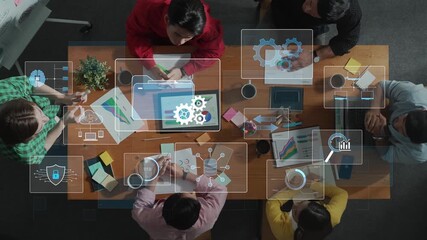 A top view captures a group of diverse professionals engaged in a productive business meeting. Digital interfaces and data analysis enhance collaboration in a modern workspace. Raster - Powered by Adobe