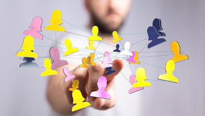 Hand reaching towards a network of connected human icons symbolizing collaboration, communication and teamwork in the digital world.