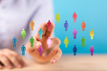 Hand reaching towards a virtual network of diverse digital people, representing connection and teamwork. Suitable for concepts of online communi