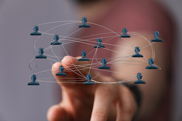 Hand touching a 3D network of connected people, symbolizing teamwork, communication, and collaboration in a digital environment. Representing gl
