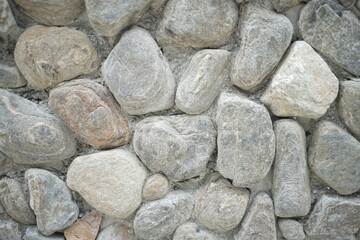 Full Frame Texture of Rounded Gray and Beige River Stones Set in Mortar