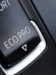 Close-up of ECO PRO mode button in a modern car. Fuel efficiency and eco driving concept. Detail of...