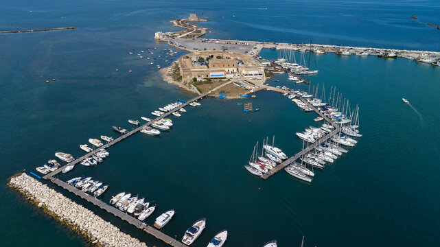 Aerial view of the port of Trapani, Sicily, Italy. It is a tourist harbor on the Mediterranean Sea. There are many small boats moored there.