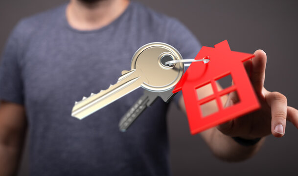 Person showing keys with house-shaped key fob representing home ownership, buying a property, and real estate deals. Perfect for illustrating mo