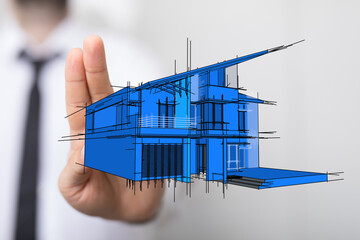 A hand holding a blueprint sketch of a modern house. The image captures architectural design,...