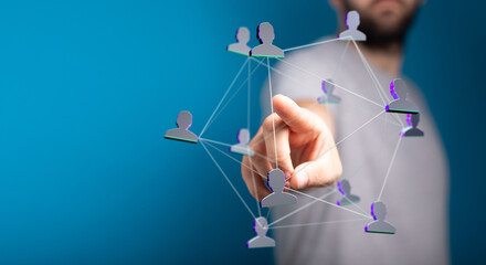 Conceptual image of human hand interacting with abstract network of people, representing social...
