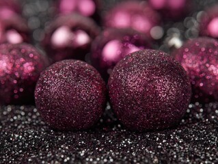 Glittery magenta ornaments on a sparkling dark background close-up. Shiny festive decorations for celebration with blurred backdrop. Abstract holiday shimmer