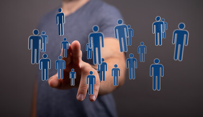 Hand pointing towards connected human icons. Concept of social network, digital collaboration, teamwork, and business relations.