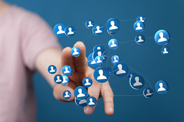 Hand reaching out to connected icons, representing social networking, communication, and digital interaction. Illustrating global connections an