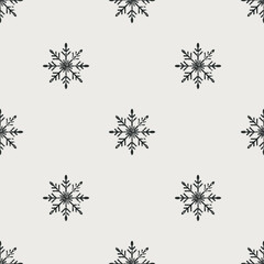 Seamless Christmas pattern. Grunge grainy snowflake texture. Festive endless vintage print. New Year's flat vector. For textile, wallpaper, wrapping design. Black snowflakes on white background.