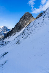 The vertical rocky walls of the summit are the only ones in the mountains that are devoid of snow cover in late autumn.