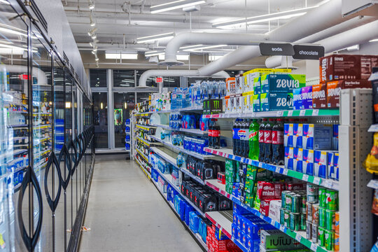 View of beverage aisle with soda, bottled water, and energy drinks in CVS supermarket background. Miami Beach. USA. 